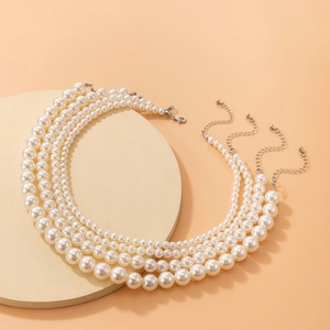 Set of four elegant pearl necklaces with various bead sizes and silver lobster clasps