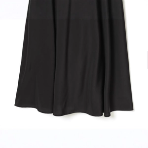 Elegant black high-waisted midi skirt with silky texture and soft flowing drapes