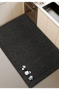 Close-up of black kitchen mat with panda pattern and striped anti-slip texture