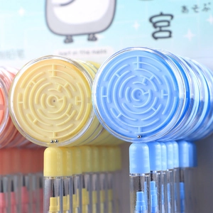 Macro view of blue and yellow creative stationery pens with integrated mini maze games