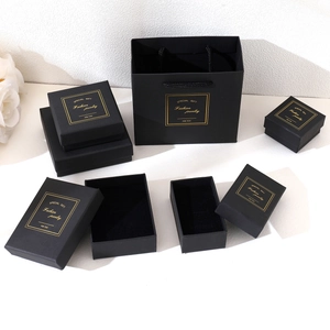 Elegant black jewelry gift boxes and bags with gold foil lettering for premium packaging