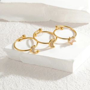 Minimalist adjustable gold ring set featuring moon and star designs with clear crystals