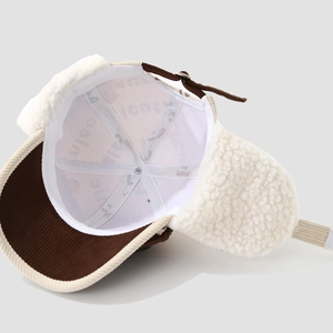 Detailed view of winter aviator hat lining with thick warm sherpa fleece and corduroy