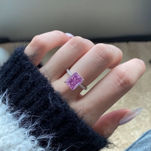 Close-up of pink square carbon diamond ring on finger showing 8A zircon detail