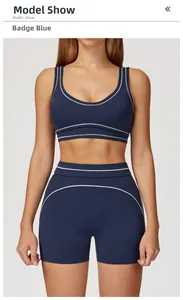 Detailed view of high-waist yoga shorts with white contrasting piping in insignia blue