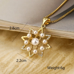 Detail view of gold star pendant necklace with pearl and zircons including size and weight