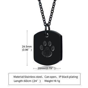 Macro shot of black stainless steel cremation urn pendant with detailed dog paw engraving