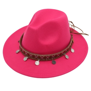 Detailed view of magenta wool fedora with ethnic style silver coins and woven band