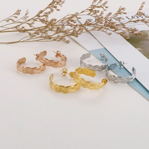 Three-color twisted C-shape earrings in gold, silver, and rose gold finish detail