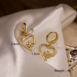 18K gold plated heart and snowflake stud earrings with crystals on white silk
