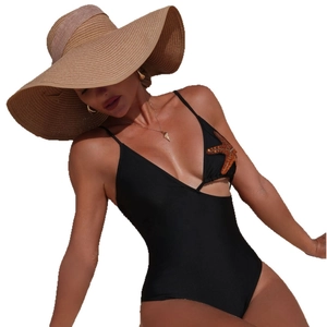 Chic black one-piece swimsuit with sequin starfish detail and cutout waist on white background
