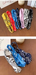 Close-up of bohemian paisley print wide elastic headbands in various vibrant colors