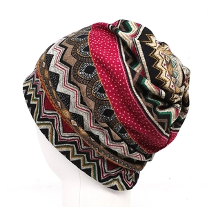 Close-up of bohemian knit beanie featuring vibrant geometric patterns on a white head form