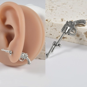 Macro shot of 16G stainless steel pistol shaped stud earring with vintage silver finish