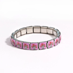 Detail of pink floral print on a stainless steel Italian charm bracelet link
