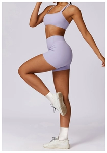 Detail of light purple yoga set featuring a strappy sports bra and high-waisted gym shorts
