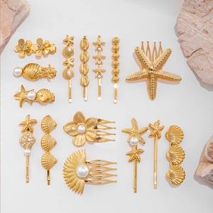 Detailed set of gold ocean-themed hair clips with starfish, shells, and pearls