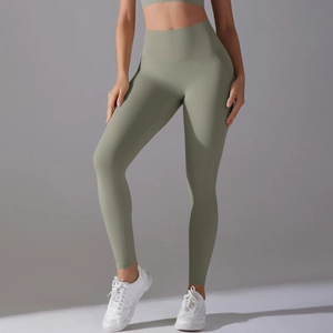 Detail view of high-waist yoga leggings and sports bra set in olive green seamless fabric