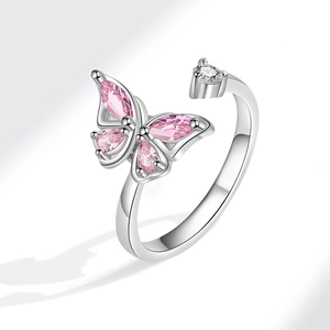 Macro view of adjustable silver butterfly spinner ring with pink zircon crystals