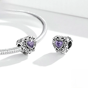 Authentic S925 sterling silver purple heart charm with intricate hollow patterns on a bracelet