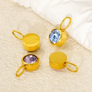 Golden stainless steel birthstone pendants with blue and purple zircons set on stone