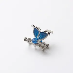 Pinza per capelli a farfalla blu glitterata con cornice argentata e strass luminosi