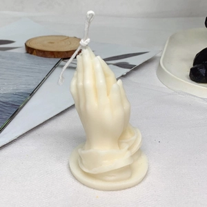 Minimalist off-white praying hands shaped scented candle for home decor and blessing