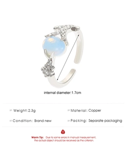 Detail view of silver copper crab ring with oval blue stone and coral texture