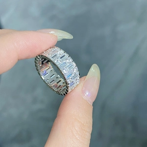 Macro shot of silver ring with pave-set rectangular and round cubic zirconia stones