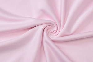 Dettaglio del tessuto piqué rosa morbido con texture a maglia traspirante di alta qualità