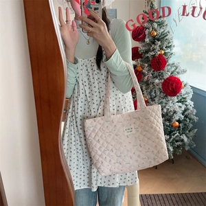 Close-up of pink floral quilted cotton tote bag with small cartoon animal prints