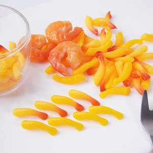 Miniature artificial shrimp tails food models for DIY crafts on a white background