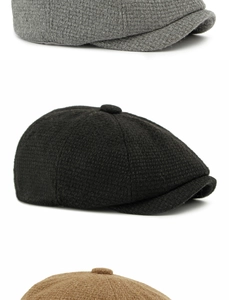 Detail view of woven textures in grey black and brown wool blend newsboy caps