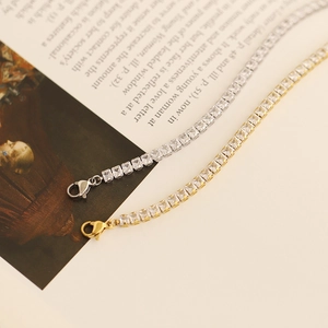 Detail of square-cut cubic zirconia tennis bracelets in gold and silver finish