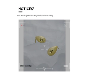 Detailed view of polished gold teardrop earrings with a minimalist geometric design