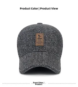 Detail of winter men's baseball cap featuring grey textured fabric and leather logo patch