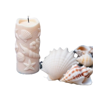 Marine themed embossed pillar candle featuring sea shells and starfish in creamy white