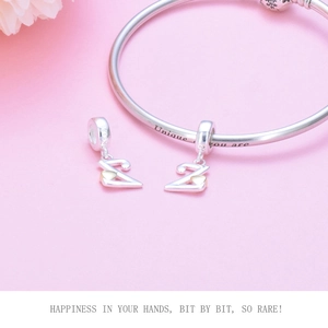 Macro shot of S925 sterling silver Z initial charm with gold heart on engraved bracelet
