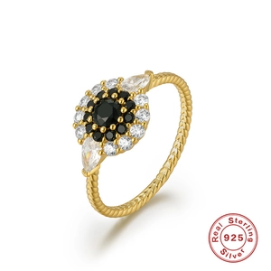 Detailed view of flower ring featuring black gemstone and twisted sterling silver band