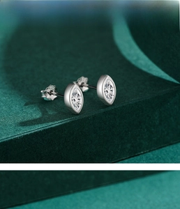 Detailed macro view of marquise-cut zircon stud earrings in polished S925 sterling silver