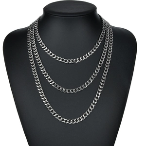 Polished silver stainless steel multi-layer Cuban link necklace on black bust display