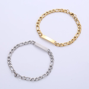 Detailed view of silver and gold Figaro chain bracelets with blank engravable ID plates