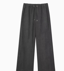 Detail of dark grey wide-leg trousers with adjustable drawstring and elastic waistband