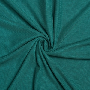 Detailed macro view of teal green knitted fabric texture and elegant drape pattern