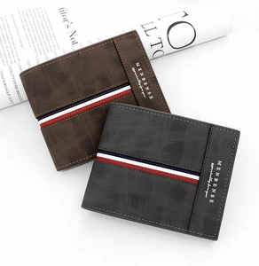 Close-up of matte PU leather texture on men's short wallets in brown and dark grey