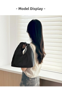 Detail of black lychee grain leather texture on soft hobo shoulder bag for women
