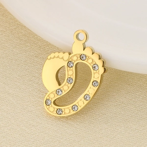 Detailed view of a golden foot-shaped pendant with sparkling crystal rhinestones for DIY jewelry