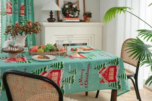 Detail of Christmas tablecloth featuring red festive house and snowflake patterns
