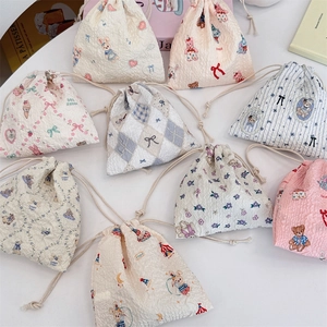 Various cute cartoon drawstring storage bags with textured bubble fabric and floral patterns
