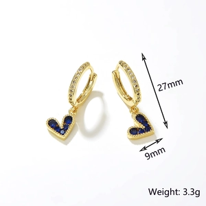 Detailed view of gold hoop earrings featuring blue cubic zirconia heart charms and crystal inlay
